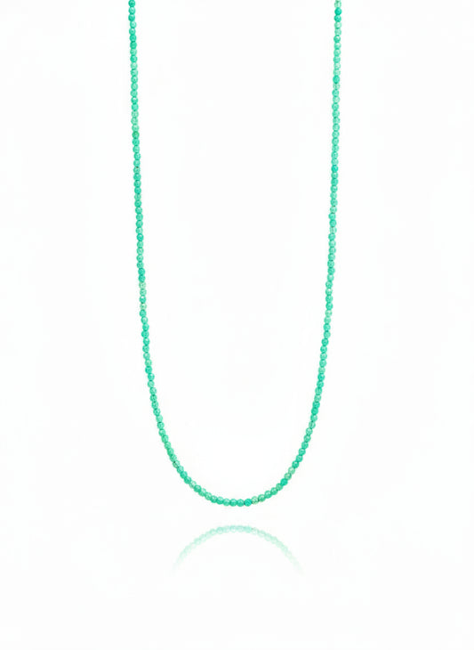 A blue gemstone necklace with a gold filled clasp, presented against a white background.