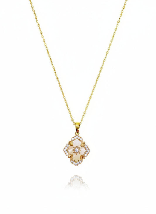 A 16K gold-filled necklace with a floral-shaped pendant featuring a central pink stone surrounded by smaller clear stones, attached to a gold-filled chain.