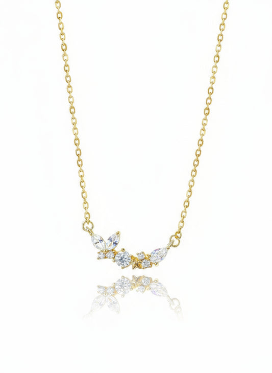 A gold filled necklace with a floral pendant design, featuring white crystals on a chain with a 2-inch extender.