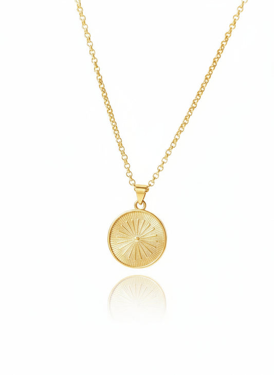A 24k gold-filled necklace with a sunburst design pendant on a white background.