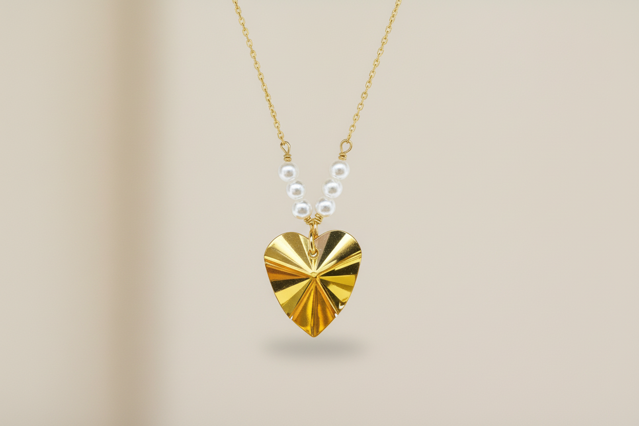 Gold heart-shaped pendant necklace on a beige background