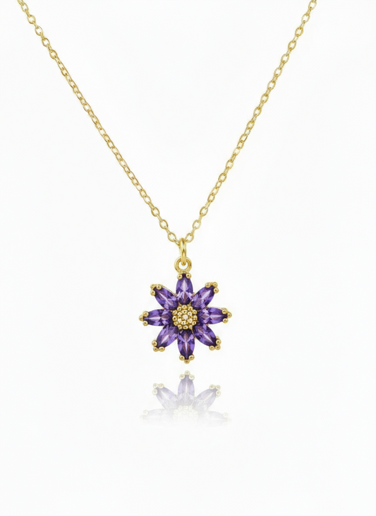 Purple flower-shaped pendant on a gold chain against a white background