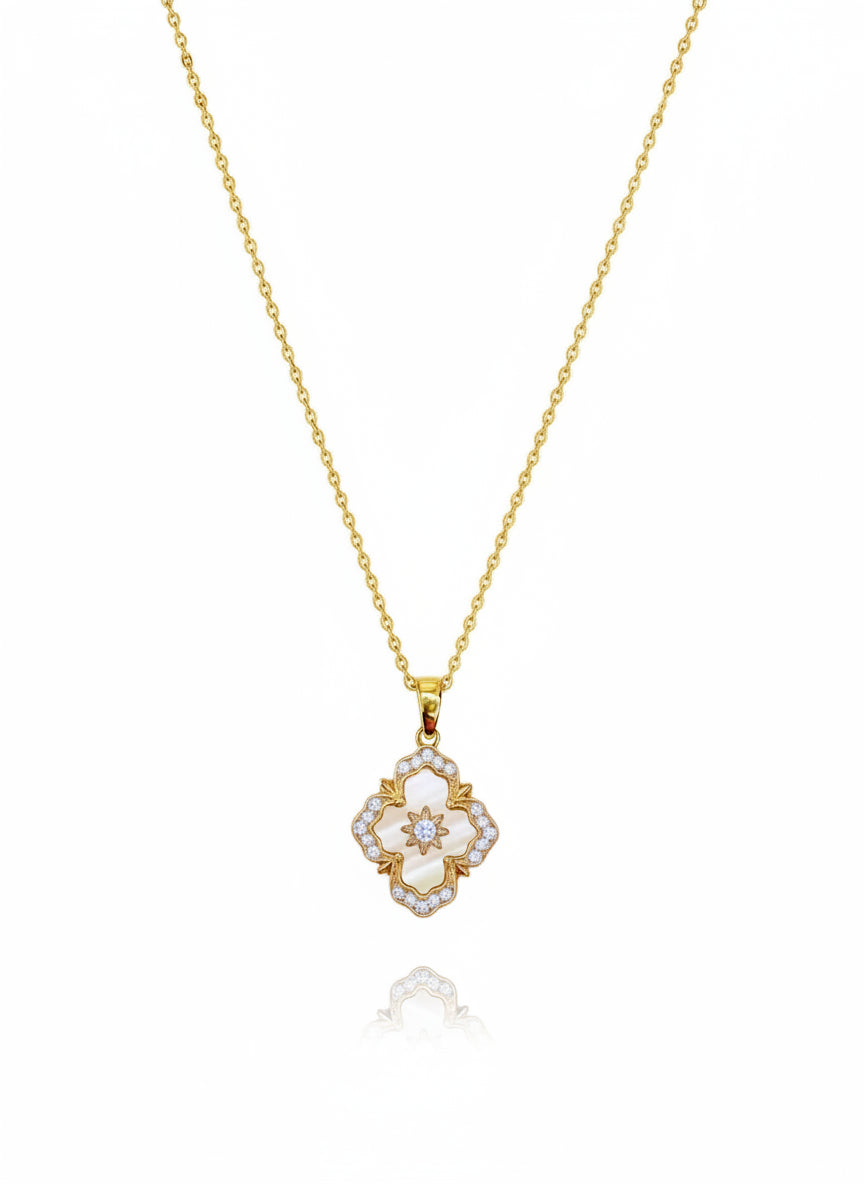 A 16K gold-filled necklace with a floral-shaped pendant featuring a central pink stone surrounded by smaller clear stones, attached to a gold-filled chain.