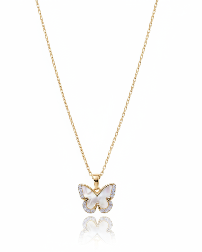 A delicate gold chain necklace featuring a butterfly pendant adorned with clear crystals, set against a clean white background with a soft reflection below.