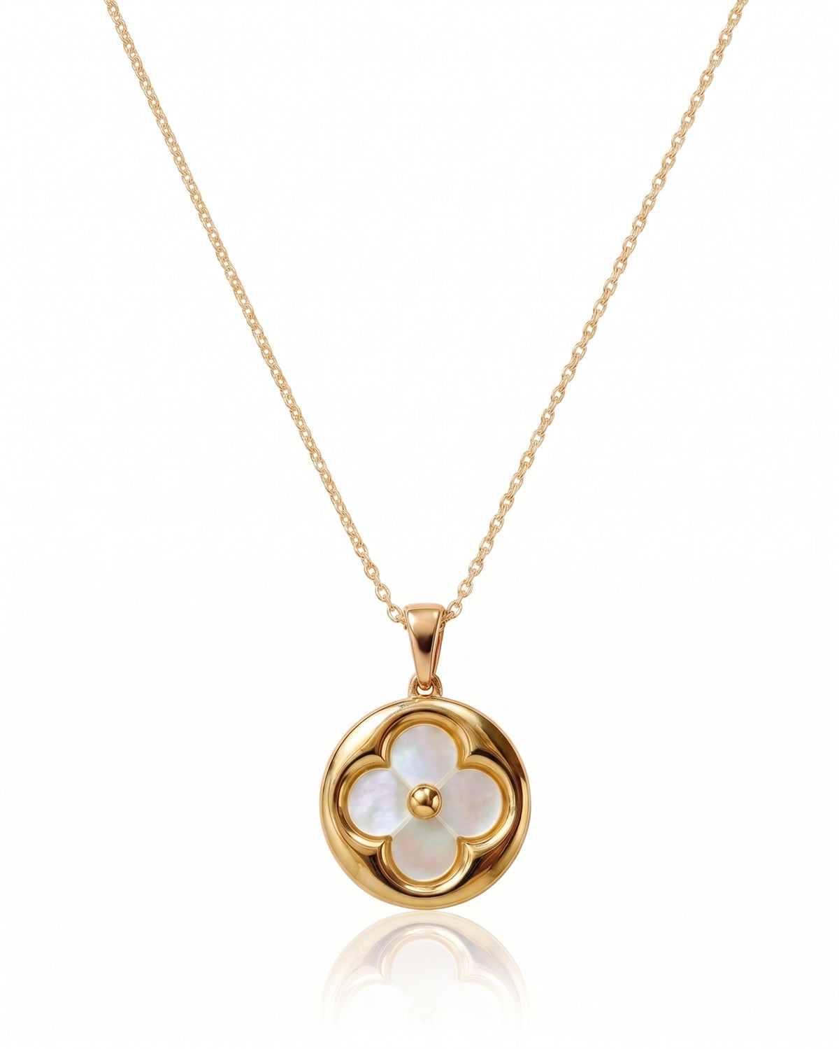 A gold chain necklace with a circular pendant featuring a four-petal flower design made of iridescent white mother-of-pearl, with a small gold center, shown on a white background with a soft reflection below. Similar to Van Cleef and Arpels necklace.