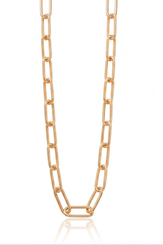 A rose gold paperclip chain necklace displayed vertically against a clean white background with a subtle reflection at the bottom.