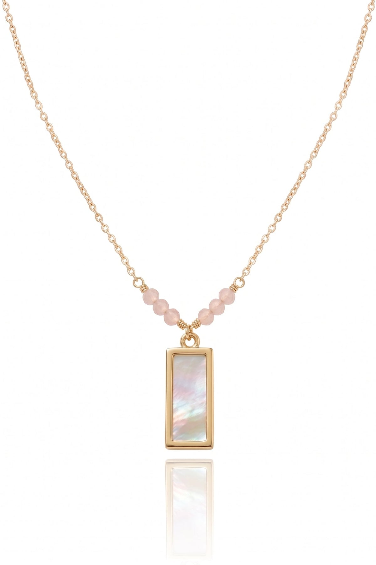 A delicate gold chain necklace featuring a vertical rectangular pendant with an iridescent mother-of-pearl inlay, accented by small pink beads along the chain, shown on a white background with a soft reflection.