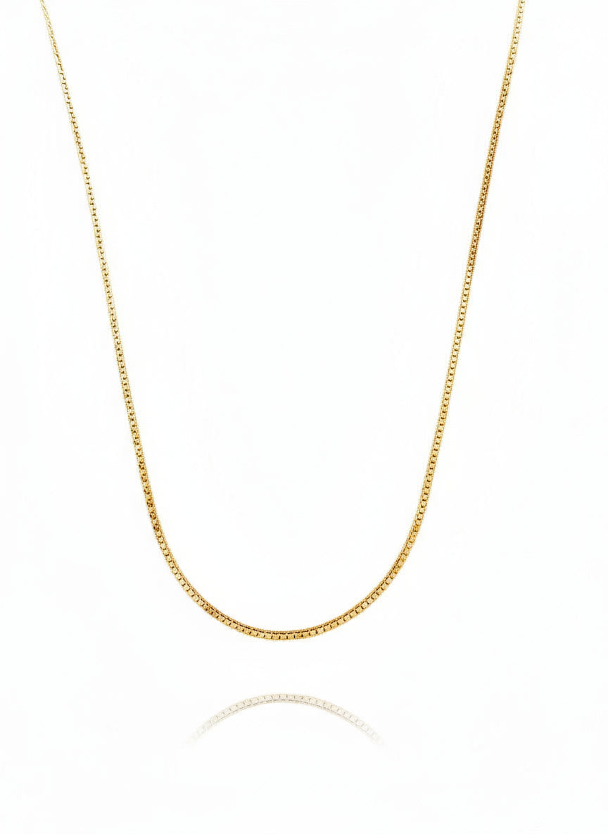 A gold-filled snake chain necklace with a 2-inch extender pendant, displayed against a white background.