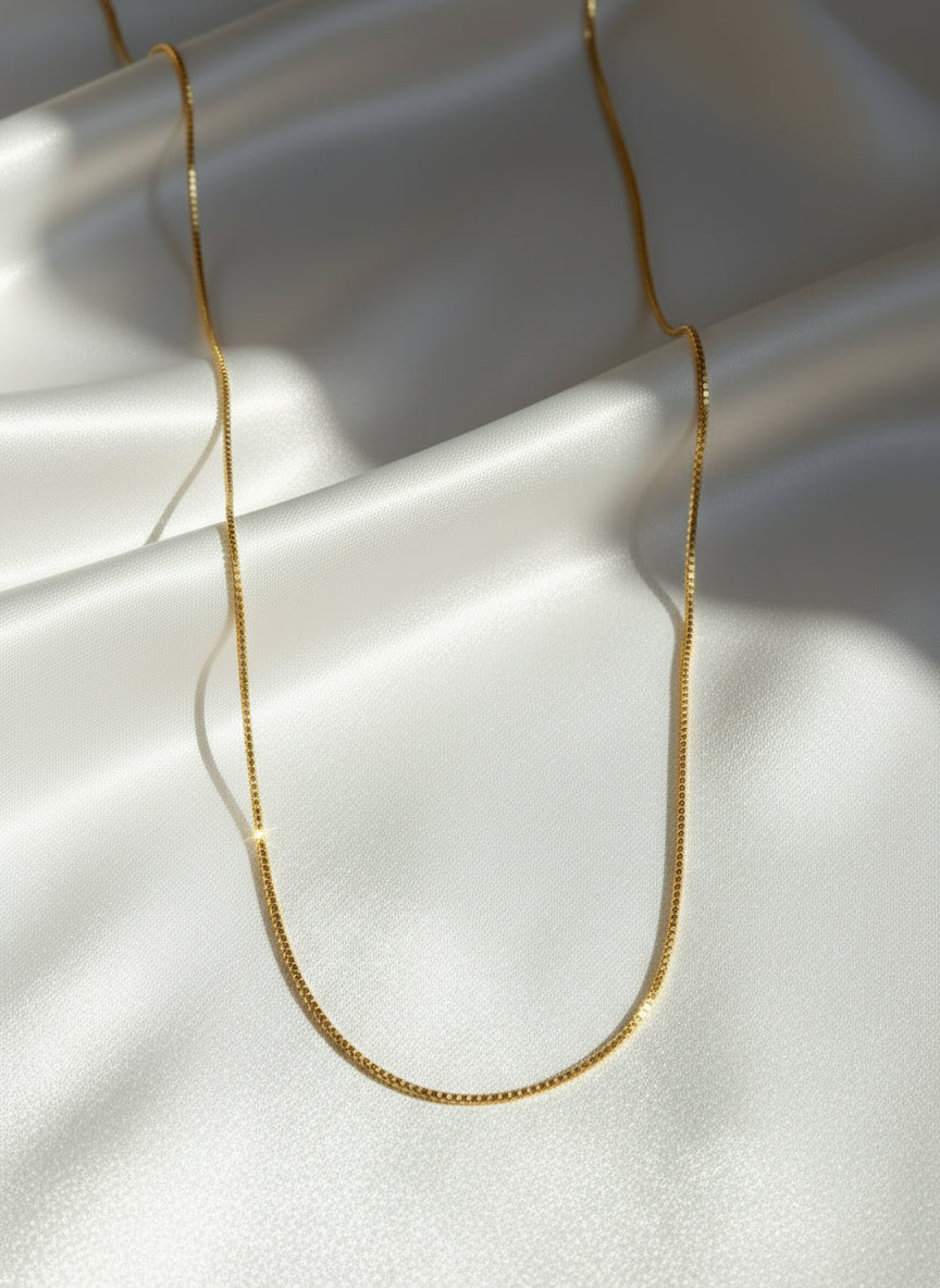 Gold chain necklace on a white background