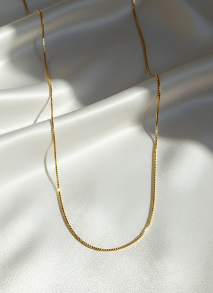 Gold chain necklace on a white background