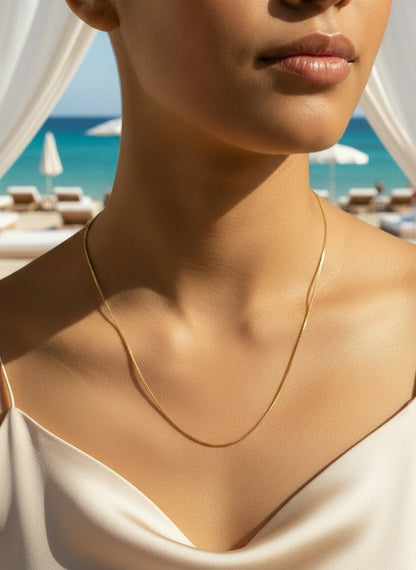 Gold chain necklace on a white background