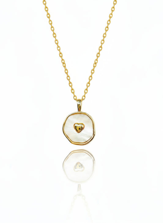 A 24K gold necklace with a gold-filled chain and a shell pearl pendant, displayed on a white background.