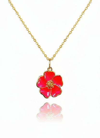 A gold-filled necklace with a pink hibiscus flower pendant on a white background.
